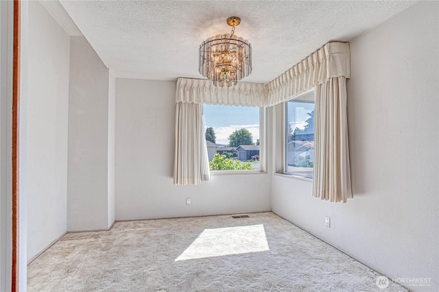 1700 Twin Peaks Dr Unit 71, Wenatchee, WA 98801 - carpeted empty room with a chandelier and a textured ceiling
