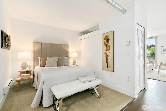 530 Broadway E Unit 612, Seattle, WA 98102 - bedroom with a baseboard heating unit, wood finished floors, and access to exterior