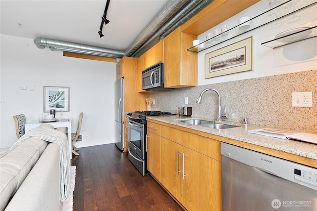 530 Broadway E Unit 612, Seattle, WA 98102 - kitchen with appliances with stainless steel finishes, backsplash, dark wood-style floors, light stone counters, and rail lighting