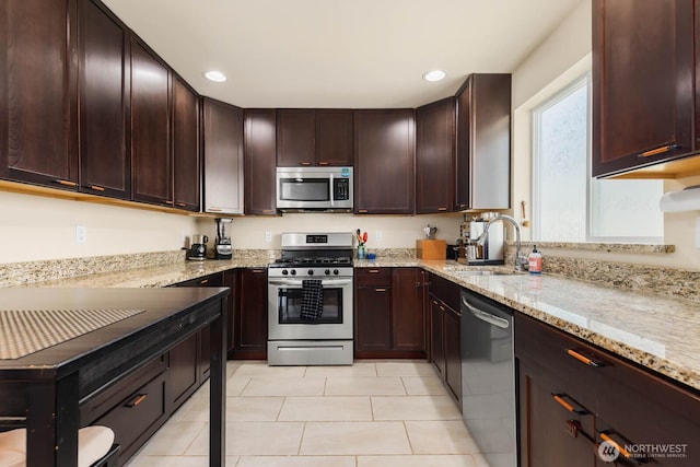 5798 Roosevelt Way NE, Seattle, WA 98105 - kitchen featuring appliances with stainless steel finishes, light tile patterned floors, light stone countertops, recessed lighting, and dark brown cabinets