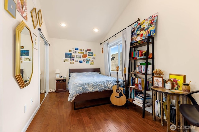 5798 Roosevelt Way NE, Seattle, WA 98105 - bedroom featuring wood finished floors, a barn door, lofted ceiling, and recessed lighting