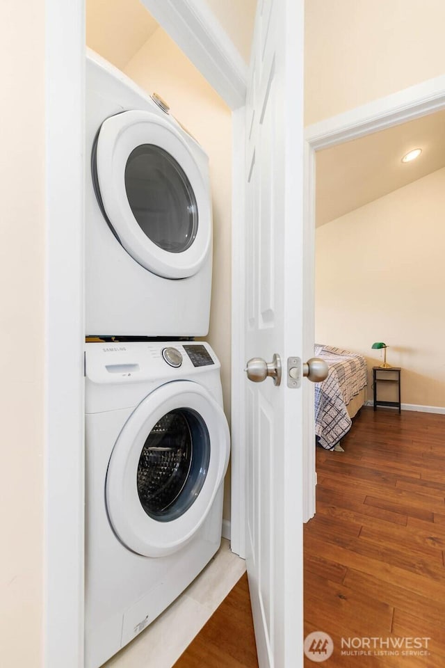 5798 Roosevelt Way NE, Seattle, WA 98105 - laundry area with stacked washer and clothes dryer and wood finished floors
