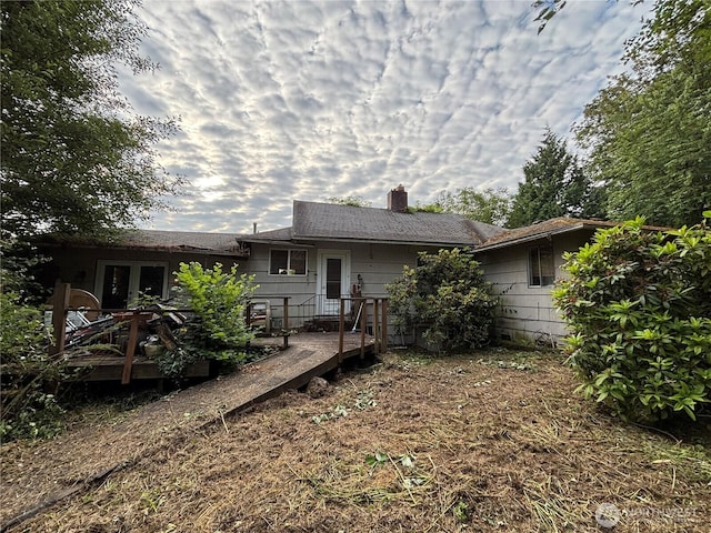 13409 40th Ave S, Tukwila, WA 98168 - back of property with a chimney, a wooden deck, and french doors