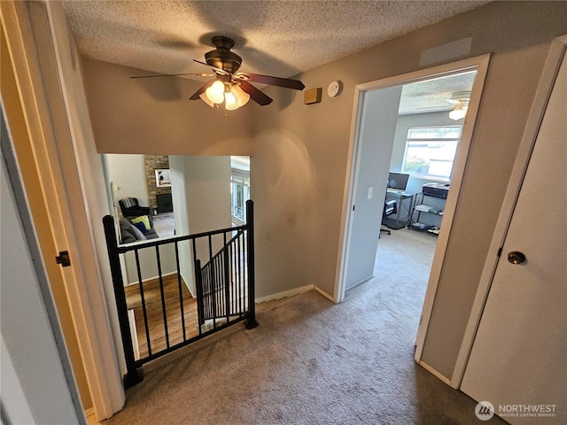 10924 SE 183rd Ct, Renton, WA 98055 - hallway with a textured ceiling, carpet floors, and an upstairs landing