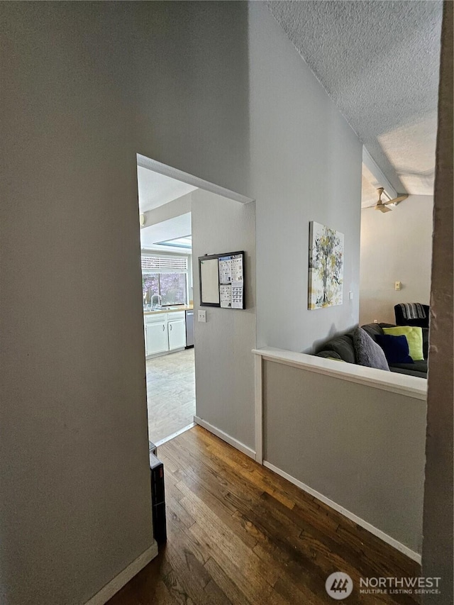 10924 SE 183rd Ct, Renton, WA 98055 - hall featuring wood-type flooring, a textured ceiling, and lofted ceiling