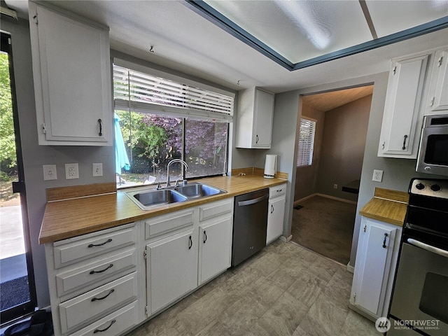 10924 SE 183rd Ct, Renton, WA 98055 - kitchen with stainless steel appliances, plenty of natural light, and white cabinetry