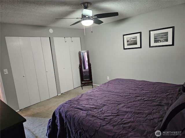 10924 SE 183rd Ct, Renton, WA 98055 - bedroom featuring multiple closets, carpet floors, a textured ceiling, and ceiling fan