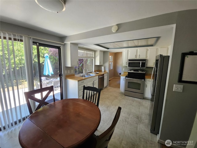 10924 SE 183rd Ct, Renton, WA 98055 - kitchen featuring appliances with stainless steel finishes, white cabinetry, and light countertops