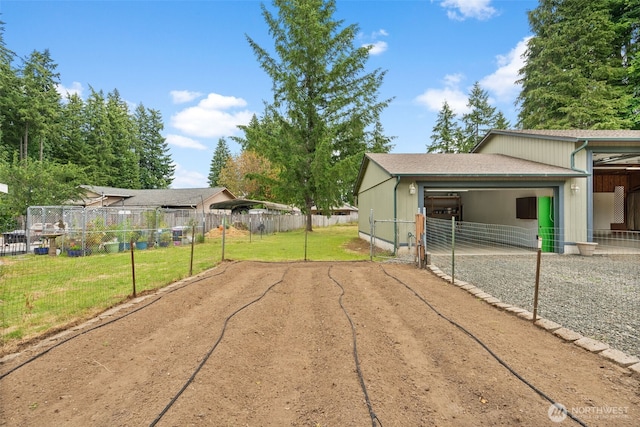 7207 Lakeside St SW, Olympia, WA 98512 - view of yard featuring driveway, an exterior structure, a detached carport, an outbuilding, and a garage