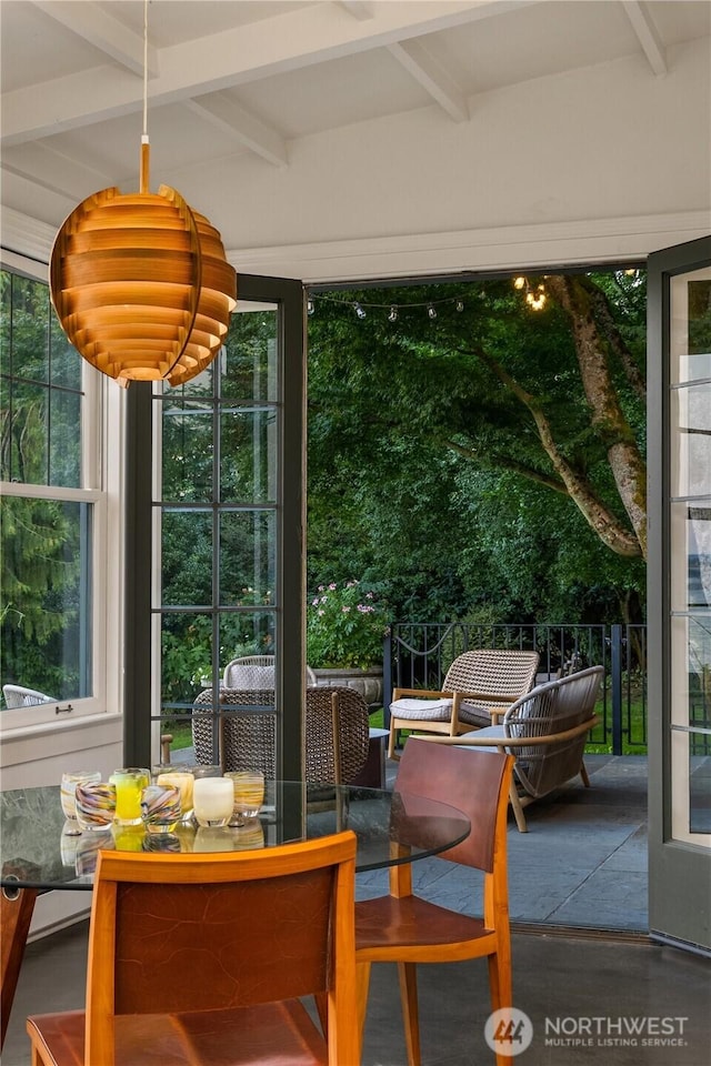 sunroom featuring beamed ceiling