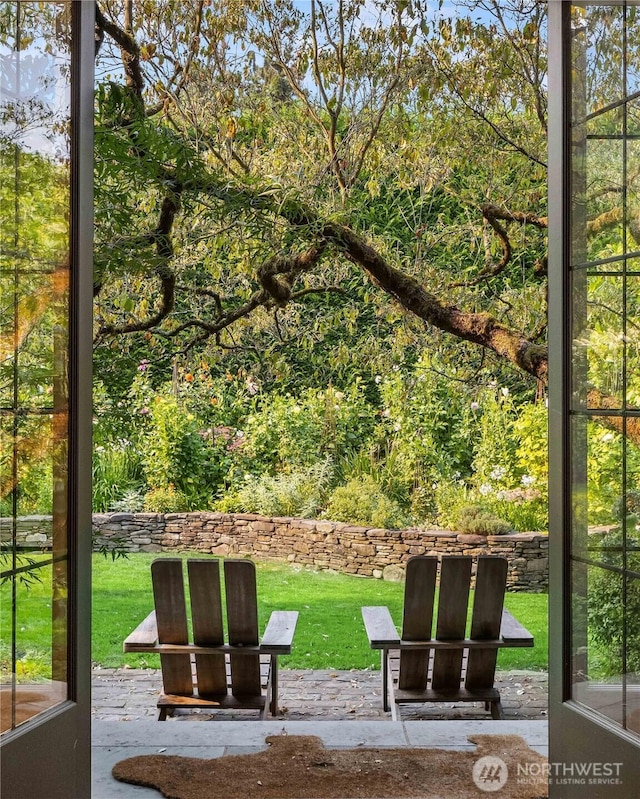 view of property's community with a yard and a patio area