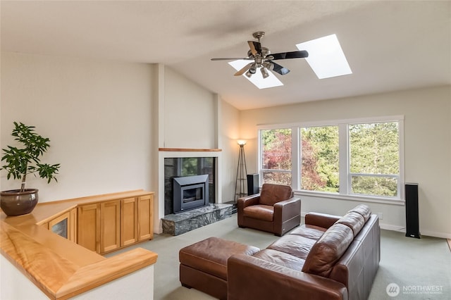 2217 W Birch, Bellingham, WA 98229 - living room featuring light carpet, a skylight, vaulted ceiling, a tile fireplace, and ceiling fan