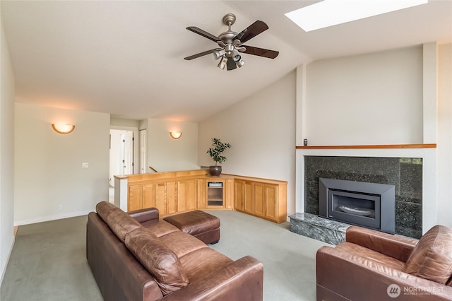 2217 W Birch, Bellingham, WA 98229 - carpeted living area featuring a ceiling fan, vaulted ceiling, a skylight, a glass covered fireplace, and beverage cooler