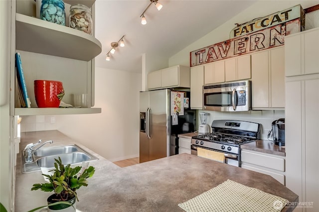 2217 W Birch, Bellingham, WA 98229 - kitchen featuring stainless steel appliances, track lighting, open shelves, vaulted ceiling, and a peninsula