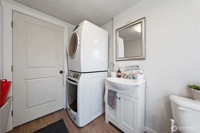 755 S Chelan Ave, Wenatchee, WA 98801 - washroom featuring stacked washer / drying machine and wood finished floors