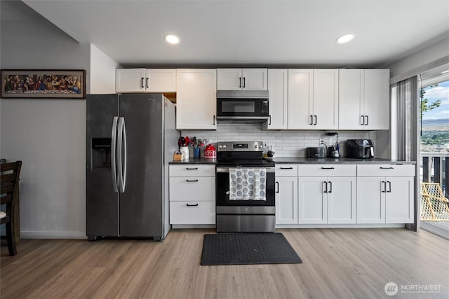 755 S Chelan Ave, Wenatchee, WA 98801 - kitchen featuring appliances with stainless steel finishes, light wood finished floors, decorative backsplash, dark countertops, and recessed lighting