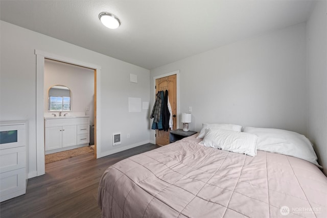 755 S Chelan Ave, Wenatchee, WA 98801 - bedroom featuring wood finished floors, a closet, connected bathroom, and a walk in closet