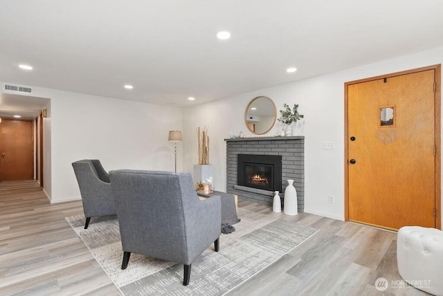 15633 47th Ave S, Tukwila, WA 98188 - living room with light wood finished floors, a brick fireplace, and recessed lighting