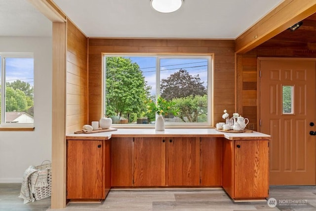 15633 47th Ave S, Tukwila, WA 98188 - kitchen featuring wooden walls, light countertops, brown cabinets, and healthy amount of natural light