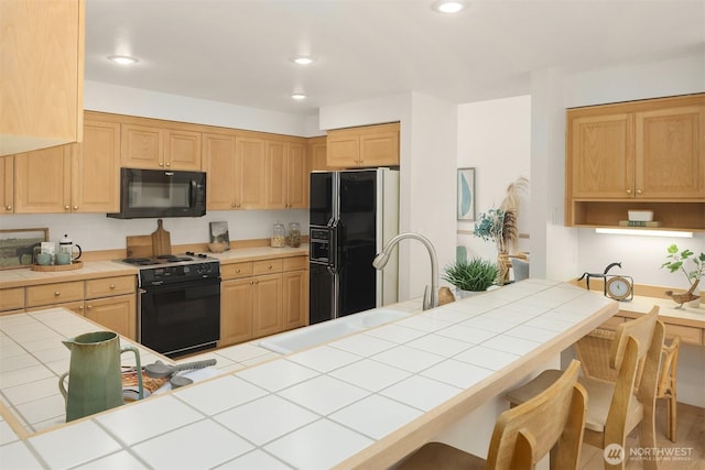 11926 SE 198th Ct, Kent, WA 98031 - kitchen with black appliances, tile countertops, a kitchen breakfast bar, recessed lighting, and light brown cabinets