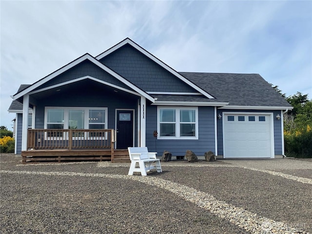 1111 Riverside Ct, Ocean Shores, WA 98569 - view of front of house with an attached garage, covered porch, roof with shingles, and asphalt driveway
