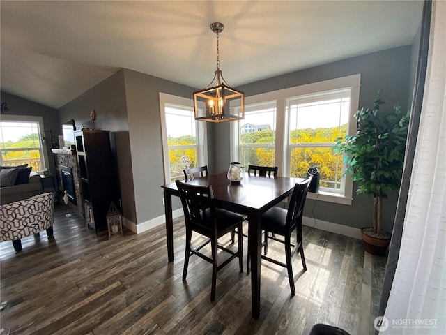 1111 Riverside Ct, Ocean Shores, WA 98569 - dining area featuring dark wood finished floors, plenty of natural light, a chandelier, and vaulted ceiling