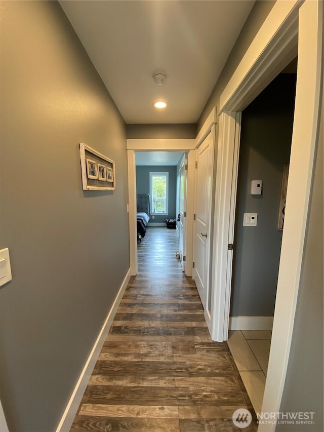 1111 Riverside Ct, Ocean Shores, WA 98569 - hall with baseboards and dark wood-style flooring