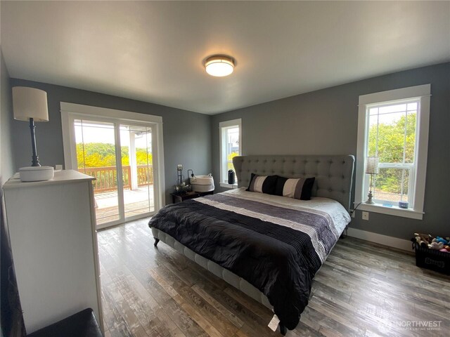 1111 Riverside Ct, Ocean Shores, WA 98569 - bedroom with access to outside, multiple windows, and wood finished floors