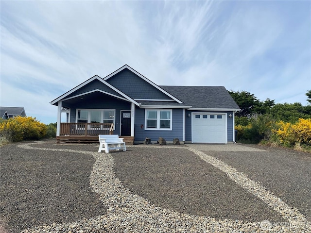 1111 Riverside Ct, Ocean Shores, WA 98569 - view of front facade with a garage, driveway, a porch, and a shingled roof