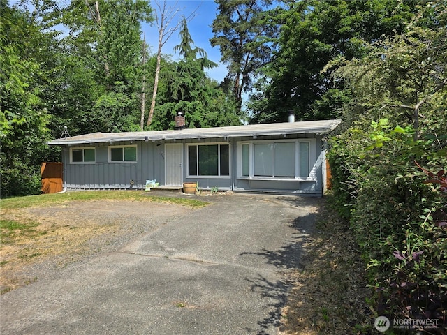 1208 SW 110th Ln, Seattle, WA 98146 - view of front of property with board and batten siding, a chimney, and asphalt driveway