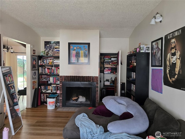 1208 NE 110th St, Seattle, WA 98125 - living room with wood finished floors, a brick fireplace, and a textured ceiling
