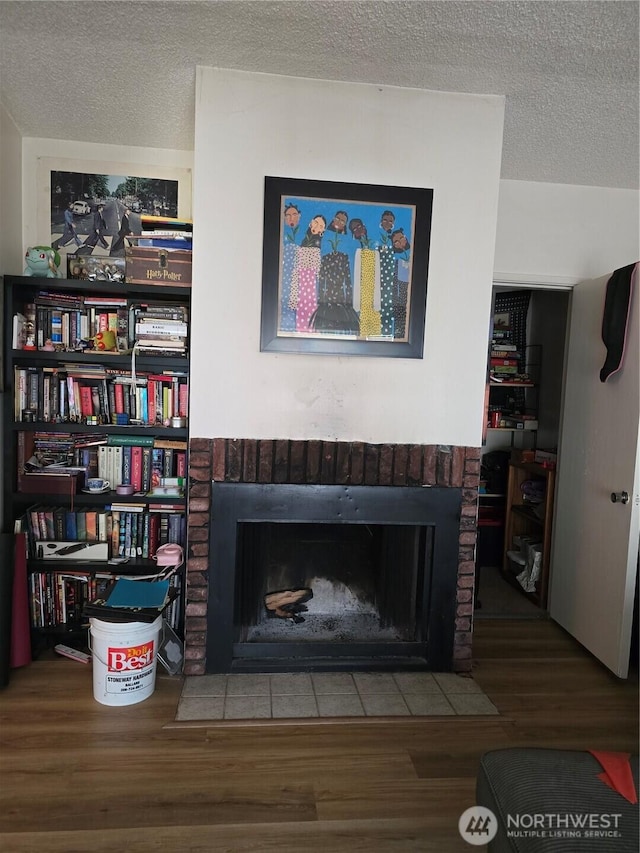 1208 NE 110th St, Seattle, WA 98125 - detailed view of a fireplace, wood finished floors, and a textured ceiling