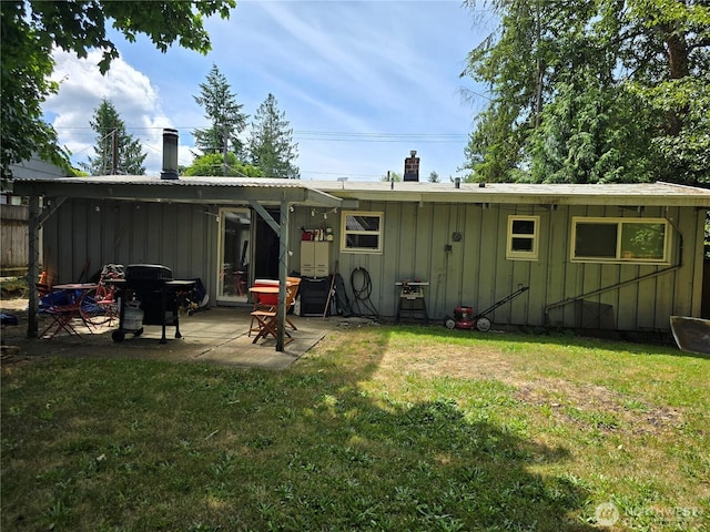 1208 NE 110th St, Seattle, WA 98125 - back of house with board and batten siding, a patio area, a yard, and a chimney