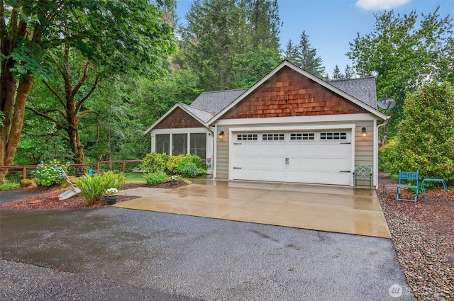 721 Abernathy Creek Rd, Longview, WA 98632 - view of front of home with driveway, an attached garage, a sunroom, and roof with shingles