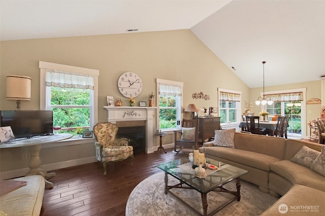 721 Abernathy Creek Rd, Longview, WA 98632 - living room with high vaulted ceiling, wood-type flooring, a chandelier, and a fireplace