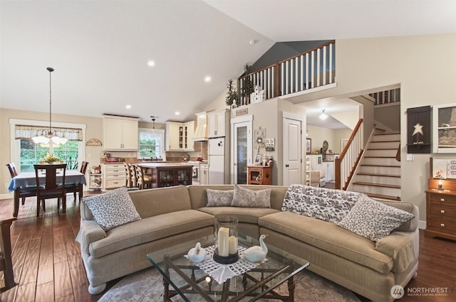 721 Abernathy Creek Rd, Longview, WA 98632 - living room featuring stairway, dark wood-style flooring, a chandelier, high vaulted ceiling, and recessed lighting
