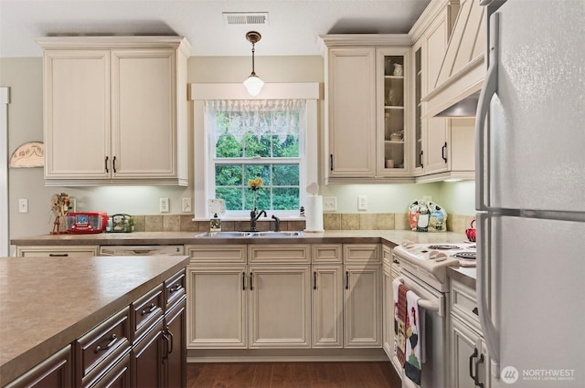 721 Abernathy Creek Rd, Longview, WA 98632 - kitchen featuring white appliances, decorative light fixtures, custom exhaust hood, glass insert cabinets, and cream cabinetry