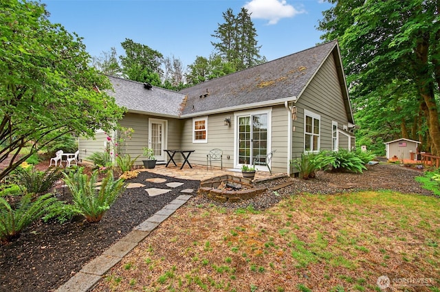 721 Abernathy Creek Rd, Longview, WA 98632 - back of property with an outdoor fire pit, a patio area, and a shed