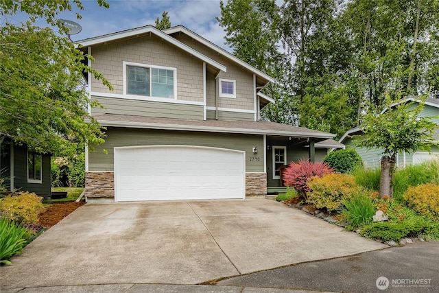 2740 Undine Pl, Bellingham, WA 98226 - view of front of home with stone siding, an attached garage, and concrete driveway