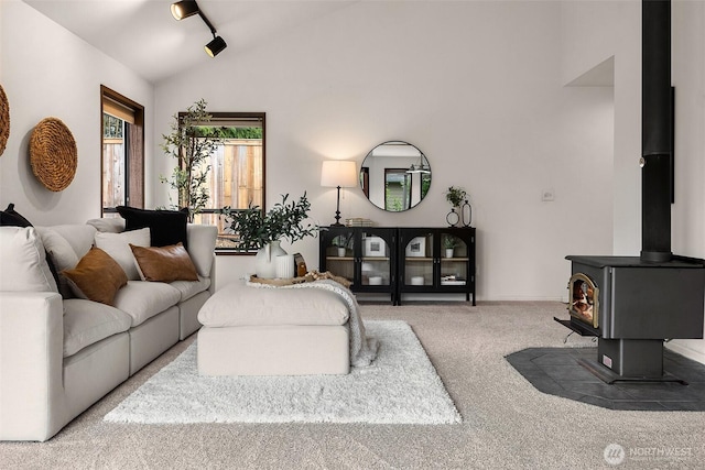 26710 NE Stephens St, Duvall, WA 98019 - carpeted living area featuring lofted ceiling and a wood stove