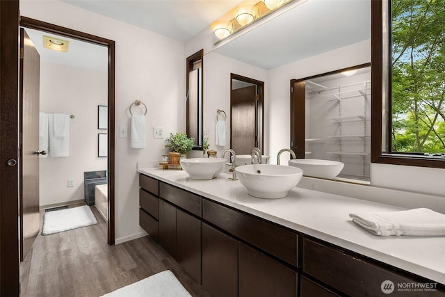 26710 NE Stephens St, Duvall, WA 98019 - bathroom with wood finished floors, double vanity, and a garden tub