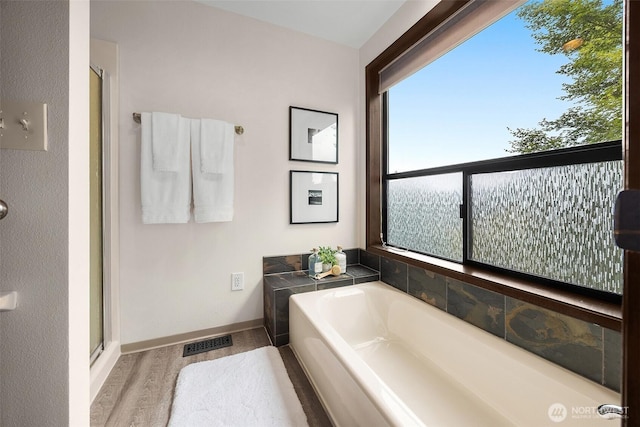 26710 NE Stephens St, Duvall, WA 98019 - bathroom with a garden tub, a stall shower, and wood finished floors