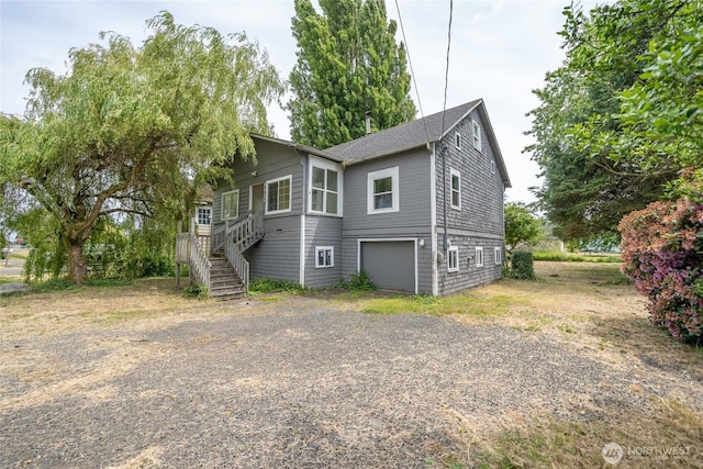 1117 W Stockwell St, Aberdeen, WA 98520 - view of front of house with driveway, a garage, and stairway