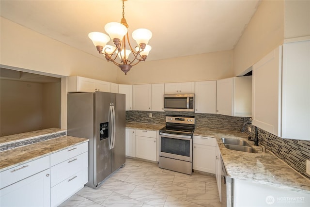 1117 W Stockwell St, Aberdeen, WA 98520 - kitchen with stainless steel appliances, decorative backsplash, light marble finish floors, a chandelier, and white cabinets