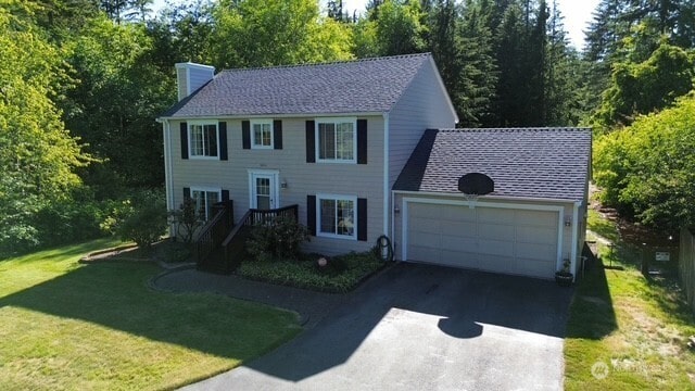 5846 SW 44th St, Port Orchard, WA 98367 - colonial inspired home with a chimney, a garage, asphalt driveway, and a front yard