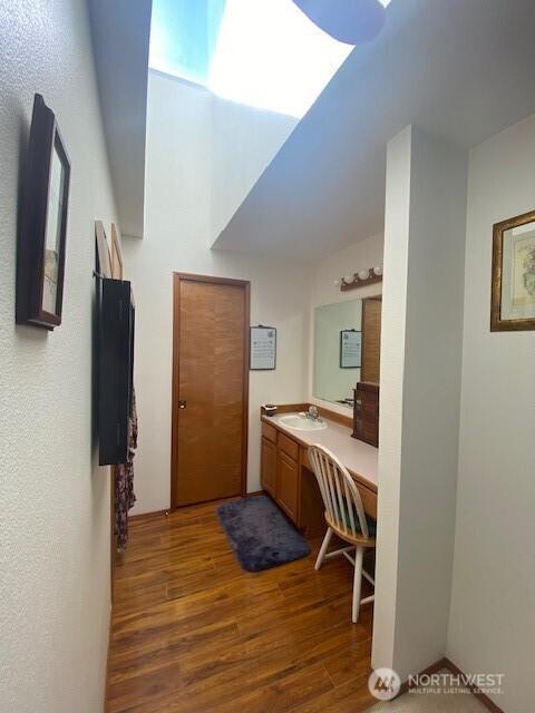 5846 SW 44th St, Port Orchard, WA 98367 - bathroom featuring wood finished floors, vanity, and a skylight