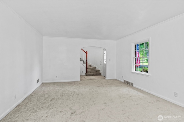 2809 Nichols Blvd, Longview, WA 98632 - spare room featuring ornamental molding, arched walkways, carpet floors, and stairs