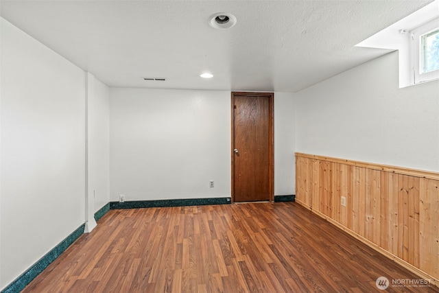 2809 Nichols Blvd, Longview, WA 98632 - spare room with wood finished floors, wood walls, and wainscoting