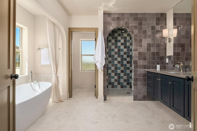 5037 25th Ave SW, Seattle, WA 98106 - bathroom featuring tiled shower, a freestanding bath, vanity, and tile walls