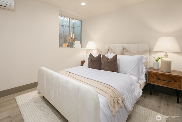 5037 25th Ave SW, Seattle, WA 98106 - bedroom featuring light wood-style floors, an AC wall unit, and recessed lighting
